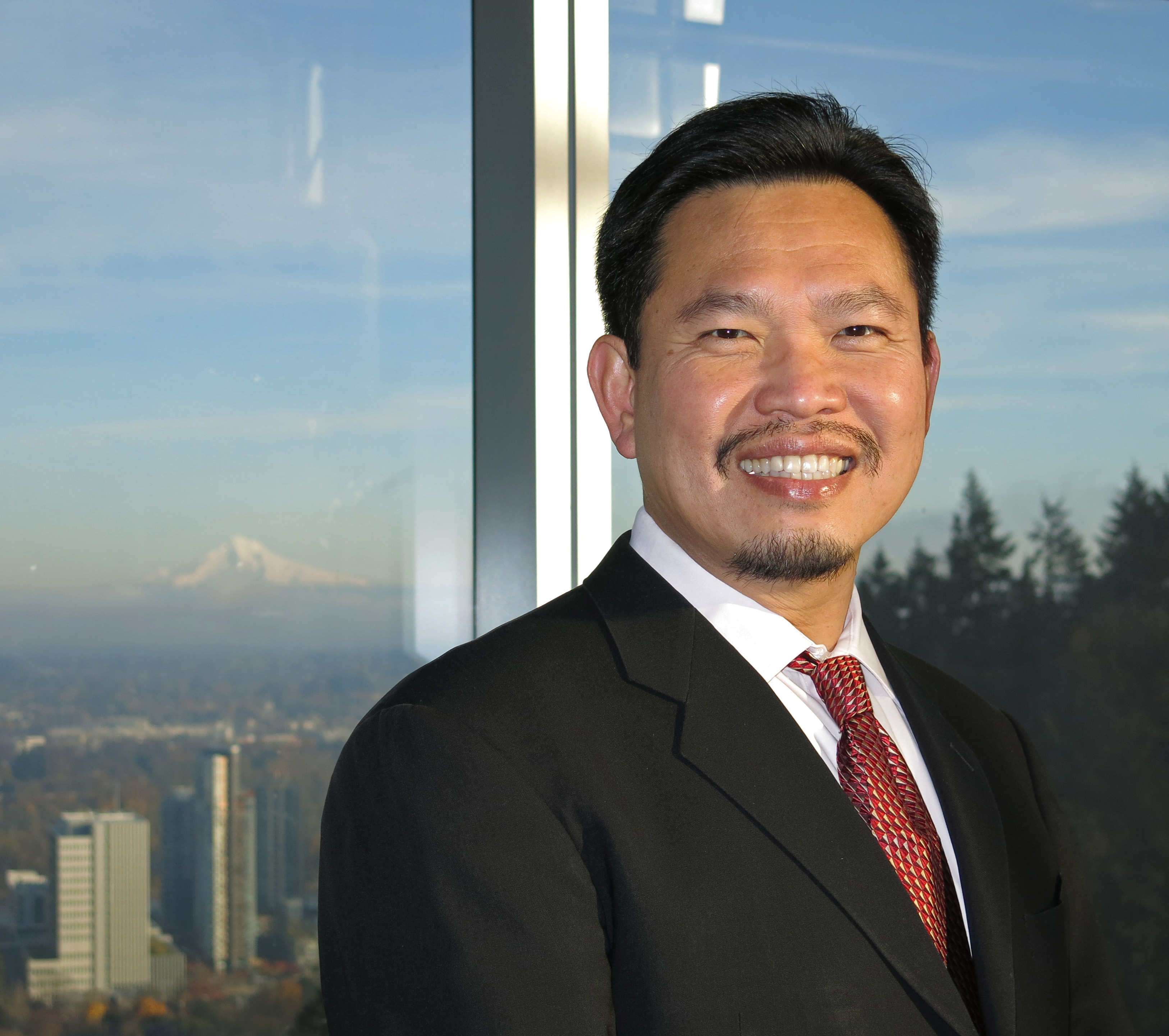 Hatfield lecturer David Huang in front of window with Mt. Hood in the background