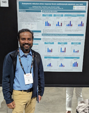 Karthik Bose by his poster at the conference.