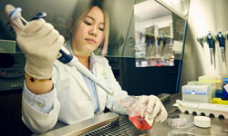 A researcher runs a test in a lab at OHSU.