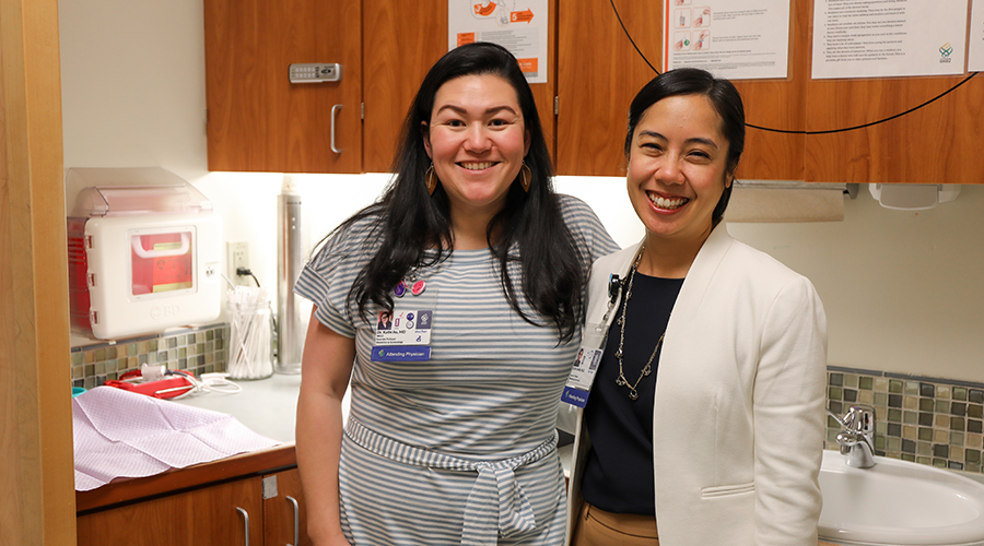 Katie Au, M.D., and Katherine Jorda, M.D., stand in a patient room at the OHSU Center for Women's Health.