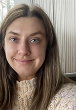 Katlin Wozniak headshot, smiling and posed in front of a neutral background