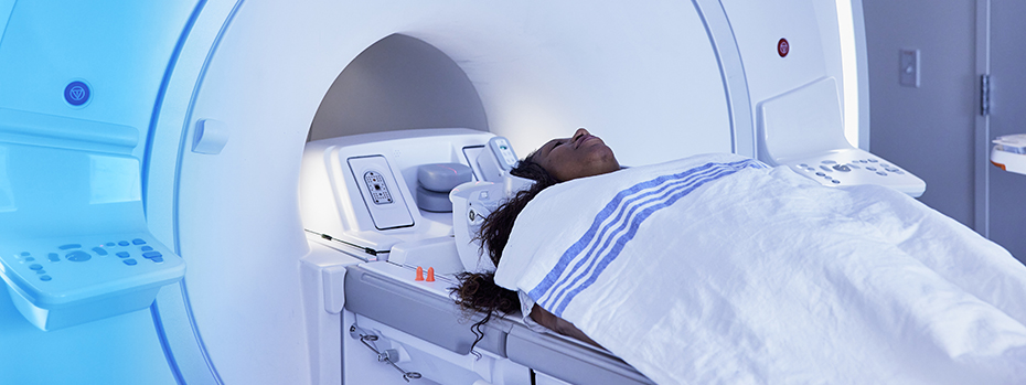 A person lies on the bed of a PET/MRI scanner at OHSU.