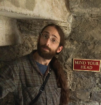 Photo of man next to sign