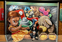 A woman sits smiling in front of a mural of children's toys.