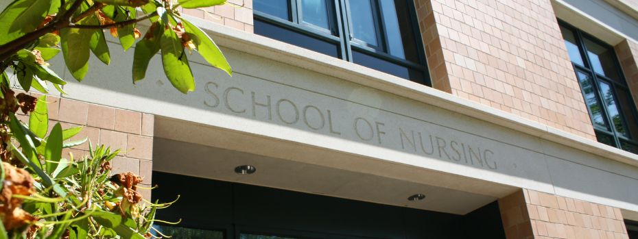 A sunny photo of the School of Nursing building in Portland, Oregon. A small tree frames the image.