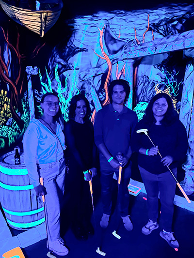 Nora Gray and lab members posed in a group while at mini-golf