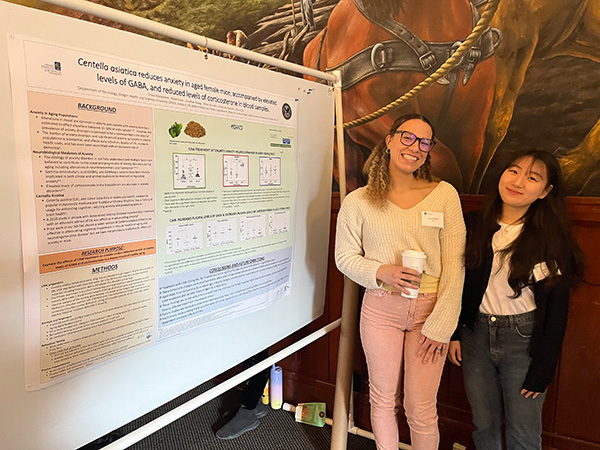 Gray lab members posed with poster