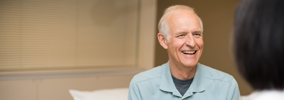 A patient smiles as he chats with OHSU vascular surgeon Dr. Enjae Jung. 