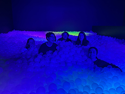 Five people in a ball pit.