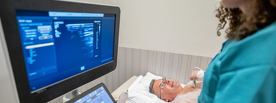 A health care provider does a neck ultrasound on a person lying on their back.