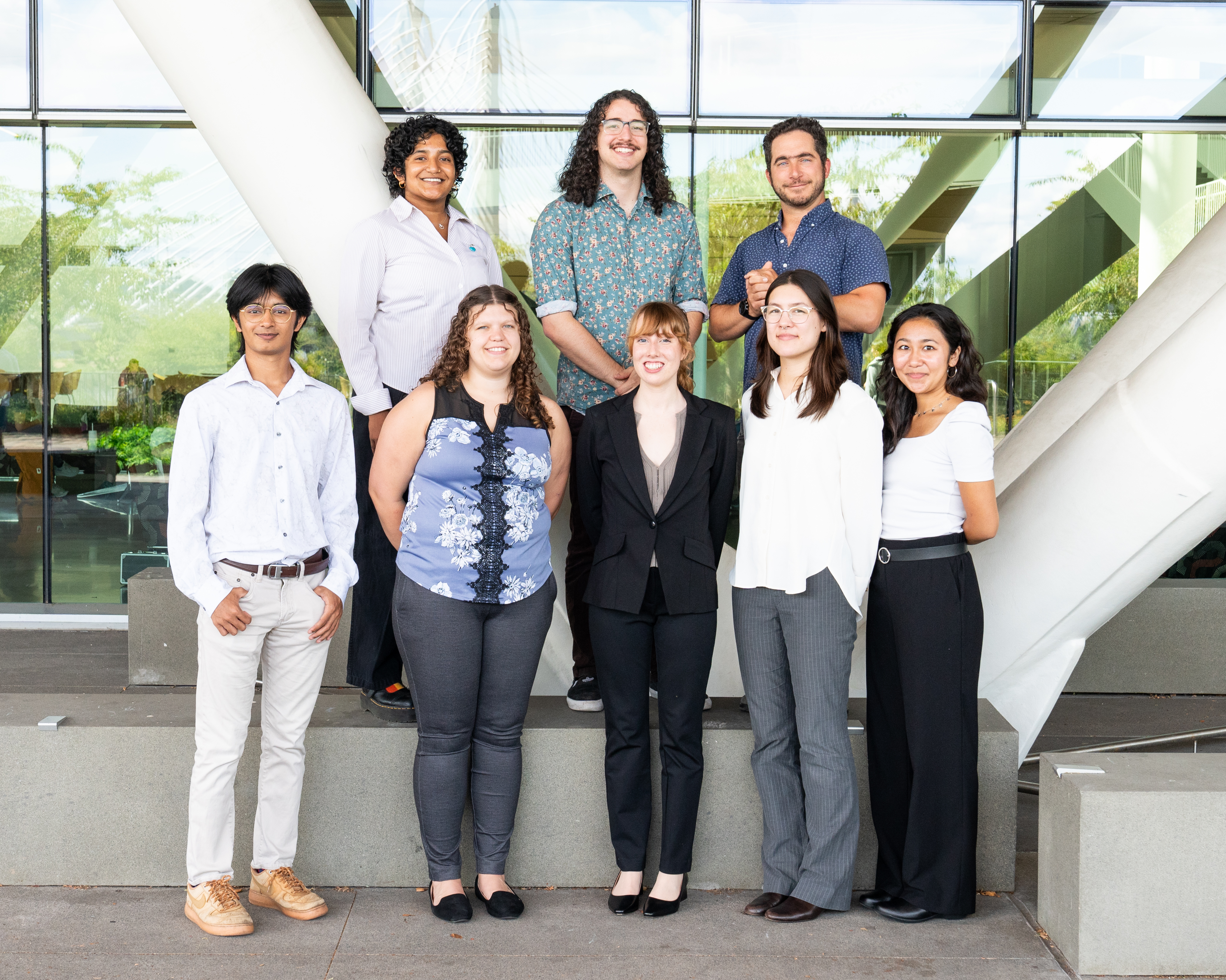 Interns and student and faculty coordinator pose for a photo together.