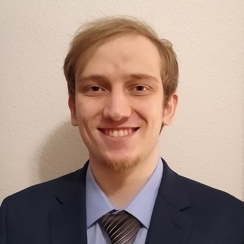 Picture of young man in grey shirt and black suit