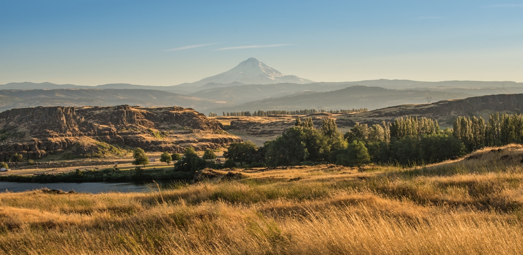 Wide view of the plains and mountains of rural Oregon with Mt. Hood in the background.