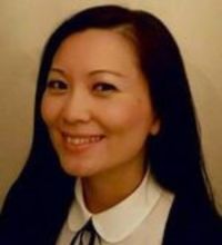 Headshot of a smiling woman with long dark hair