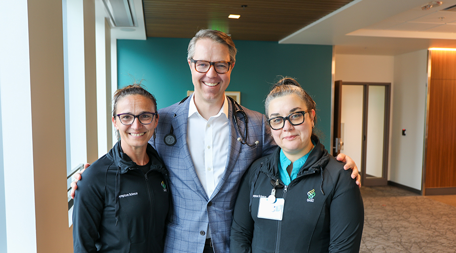 Eric Roeland stands in between two of his team members.