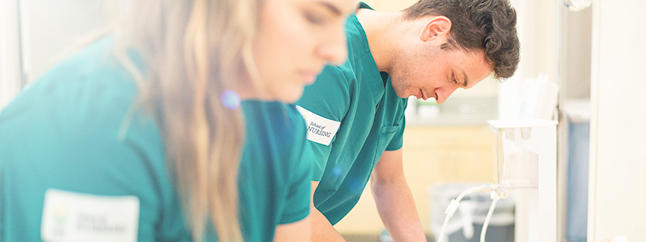 Two OHSU nursing students reviewing patient information together in a clinical setting.