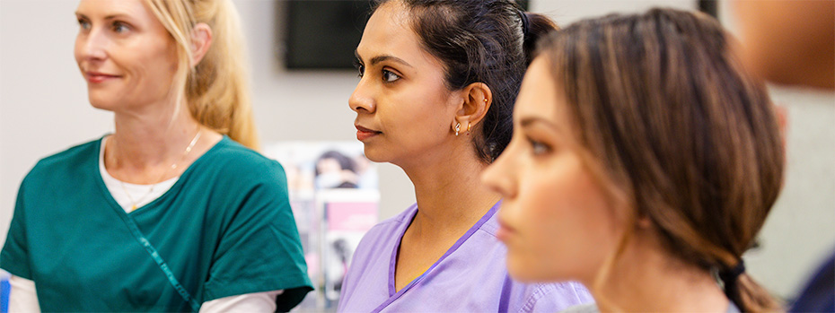 A group of OHSU nursing students listens attentively during a classroom session.