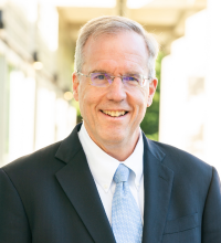 Dean Selden, smiling in a suit